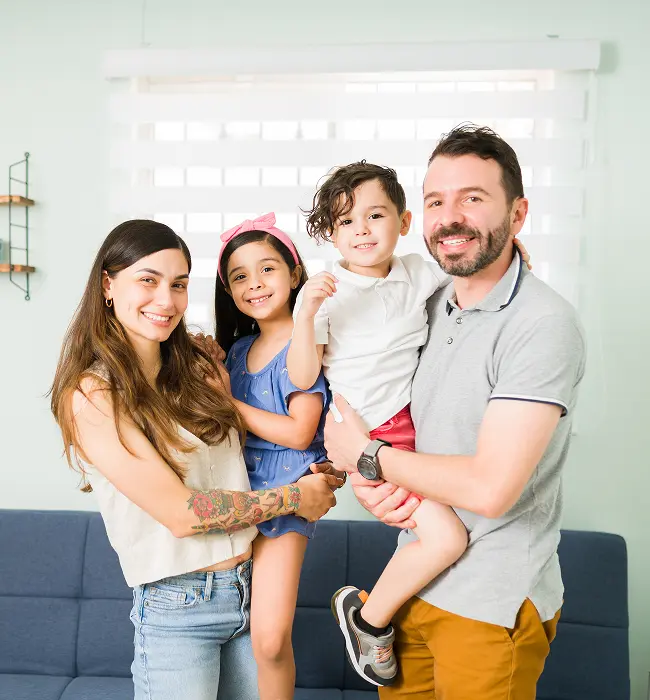portrait-beautiful-family-four-with-adorable-little-children-smiling-making-eye-contact-while-spending-relaxing-day-together-home